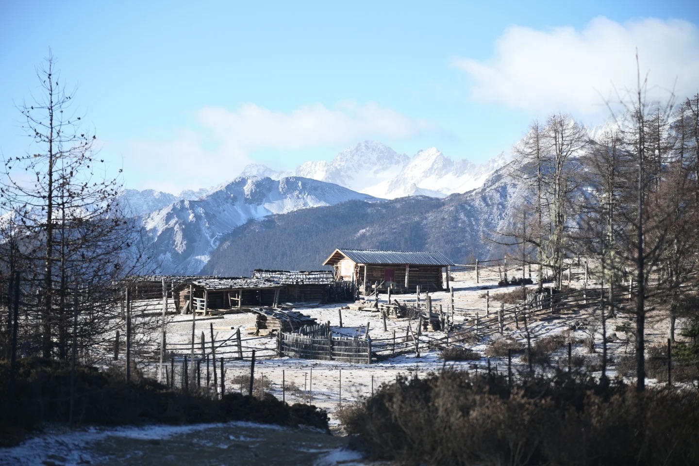 Yak corral and cabin in alpine winter light with the Meili snow peaks behind — Meili North Slope trek by Boutique China